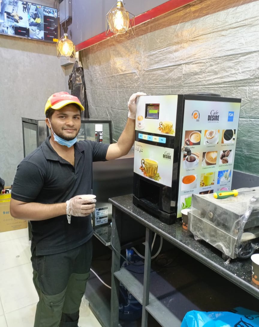 Barista using Café Desire machine at a coffee shop